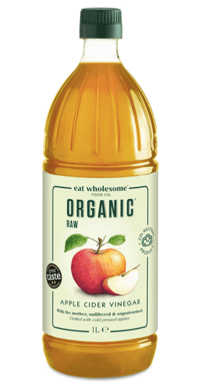 Bouteille de vinaigre de cidre de pomme biologique, 1 L, avec une étiquette indiquant 'RAW' et des images de pommes.
